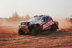 Close up of CST Sponsored team BAS AUTO SPORT vehicle in an action shot, kicking up dirt.