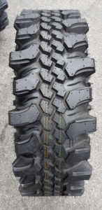 Full tread view of custom grooved tread blocks on a CST Land Dragon