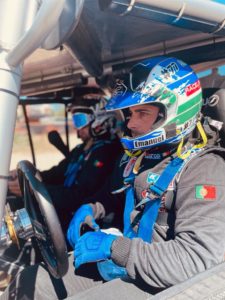 Emanuel Costa in vehicle and in full racing gear with co-driver.