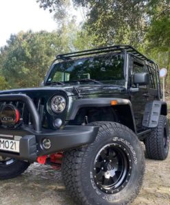 Three quarter cropped view of Emanuel Costas Jeep Wrangler front driver side wheel sporting CST SAHARA AT II Tires