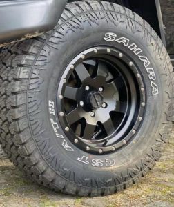 Three quarter cropped view of Emanuel Costas Jeep Wrangler front driver side wheel sporting CST SAHARA AT II Tires