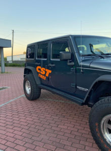 Three quarter cropped view of Emanuel Costas Jeep Wrangler with CST Tires logo branding on the side