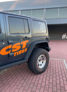 Three quarter cropped close up view of Emanuel Costas Jeep Wrangler with CST Tires logo branding on the side