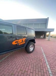 Three quarter cropped view of Emanuel Costas Jeep Wrangler with CST Tires logo branding on the side