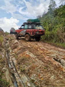 Team 4x4 Malaysia Land Rover off-road vehicle with Land Dragon tires on rough terrain.