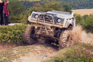 Image of white Land Rover with CST Land Dragon tires in the in the UK, action photoshoot, climbing up a hill.