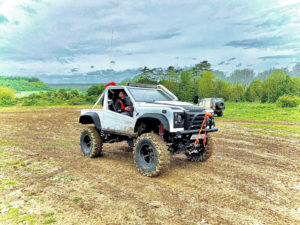 Image of white Land Rover with CST Land Dragon tires in the in the UK, action photoshoot on off-road terrain.