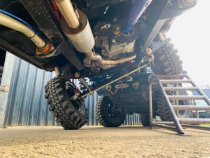 Image of white Land Rover with CST Land Dragon tires in the in the UK, photoshoot, under vehicle view perspective.