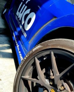 Angled perspective view of CST MEDALLION MD-A1 mounted on blue Mazda RX8 with custom wheels.