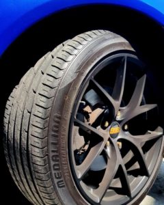 Close-up of CST MEDALLION MD-A1 mounted on blue Mazda RX8 with custom wheels.