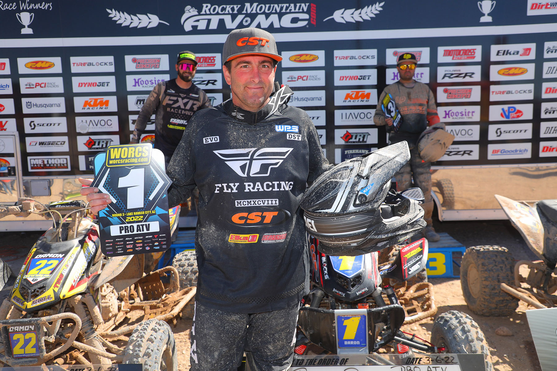 Beau Baron holding a 1st place trophy and helmet